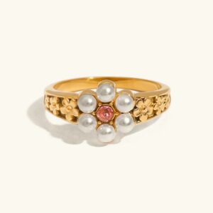18k gold freshwater pearl floral ring flat lay - elegant botanical design with white pearls and central gemstone on off-white background
