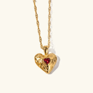 18K gold hammered heart pendant necklace with twisted chain close-up front view on plain background