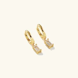 18K gold baguette drop huggie earrings with zircon charms flat lay product shot on neutral background showcasing full design