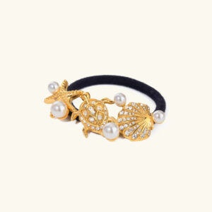18K gold starfish pearl hair cuff front view flat lay with black elastic band on light background
