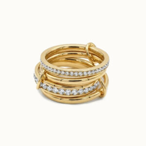 18K gold stacked diamond ring flat lay product shot showing layered polished gold bands with pavé diamond accents on white background