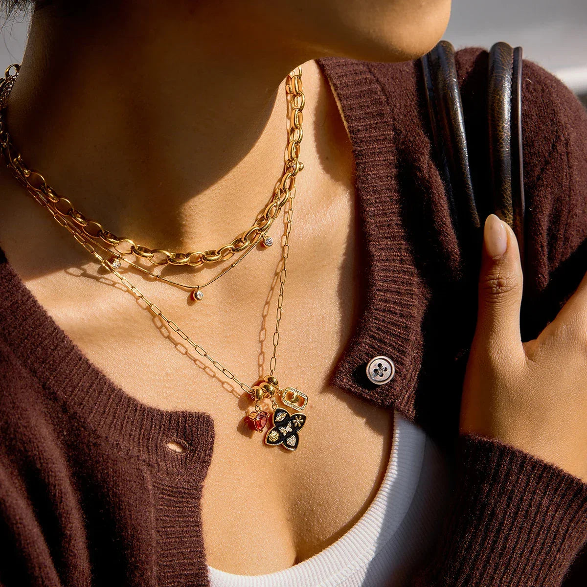 layered 18k gold necklace set side view on female model with bag strap daily wearing effect