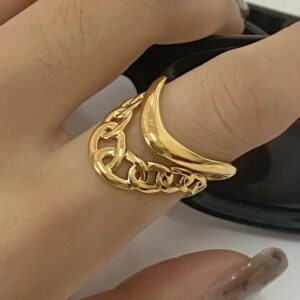 18K gold paisley arc ring on hand, stackable ring styling with manicured female hand, close-up side view, layering multiple gold rings