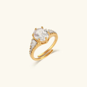 18K Gold oval CZ diamond simulant solitaire ring with baguette side stones and split band design, flat lay product photography showing high sparkle and light refraction