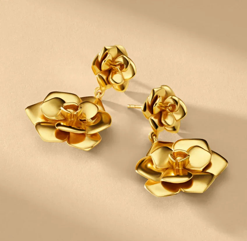 18K gold camellia drop earrings quality specification sheet overhead flat lay highlighting hypoallergenic tarnish-free water-resistant properties