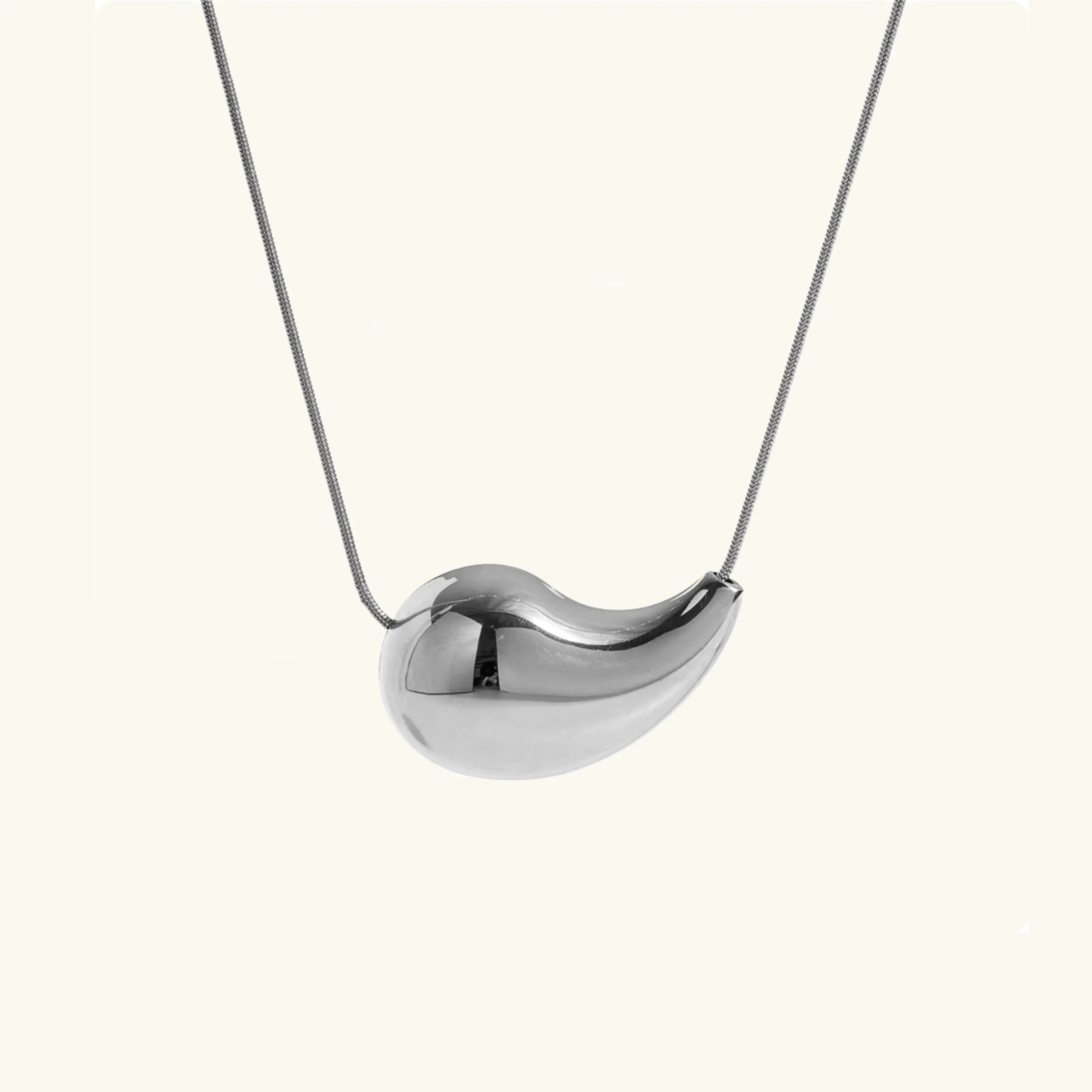 Silver teardrop drop necklace front view - polished silver pendant on slim chain against plain background
