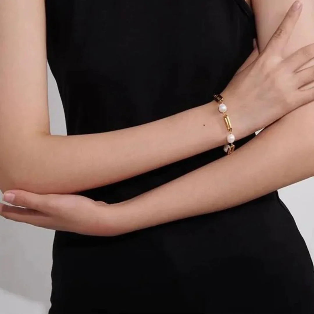 Slim 18K gold pearl bracelet side arm view thin gold beads small pearls delicate design on model