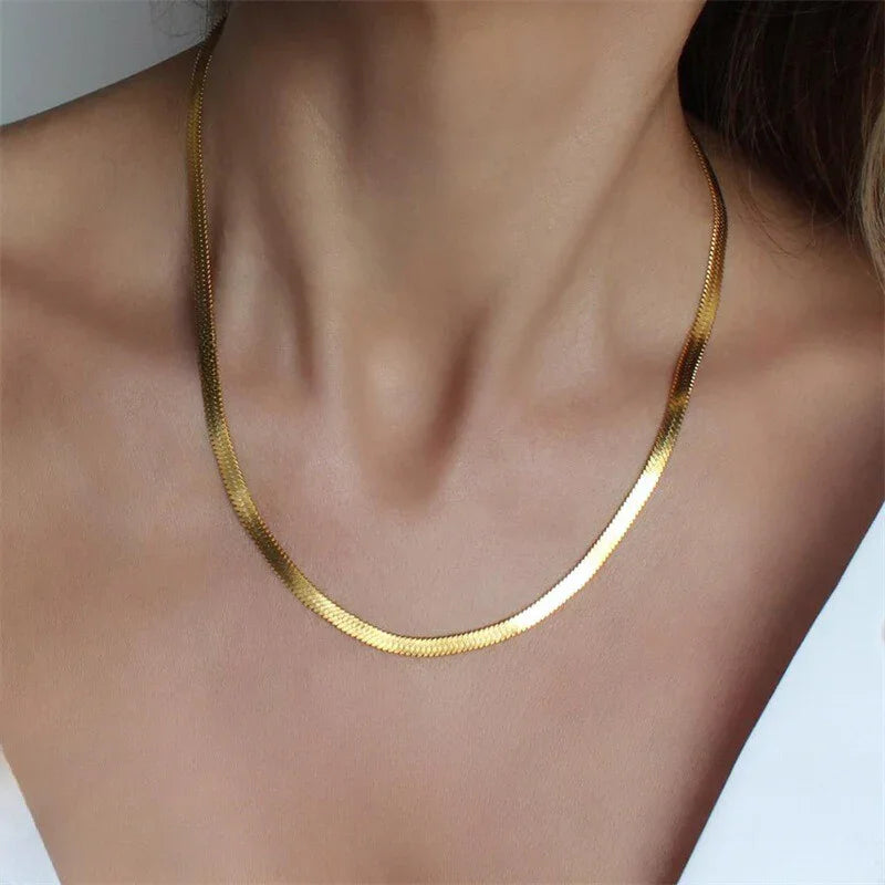 Bold 5mm gold herringbone collar necklace statement piece worn on model showing substantial luxury chain