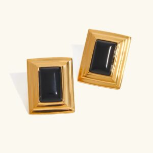 Black and gold square enamel stud earrings flat lay product shot featuring polished gold border with solid black enamel center
