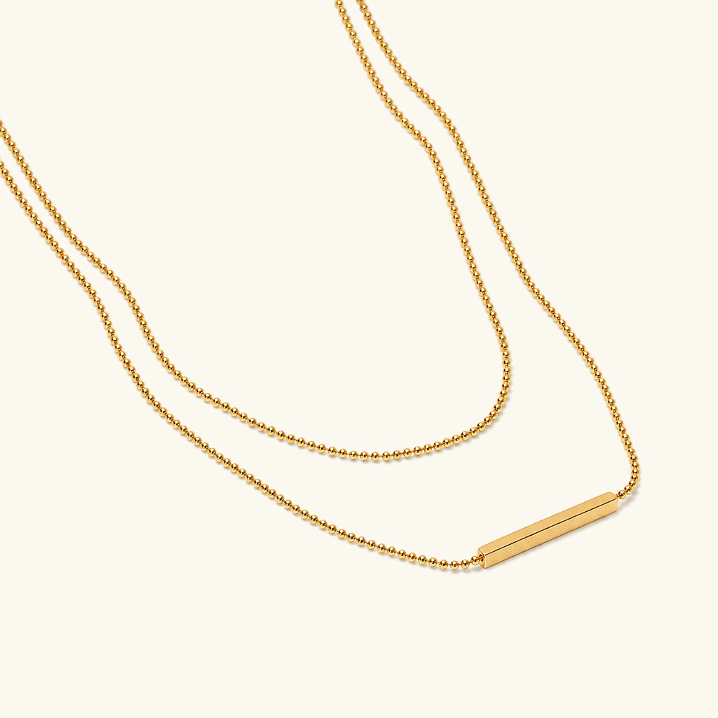 18K Gold Layered Bar Necklace flat lay display showing complete design with staggered double chain and horizontal bar element