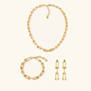3-piece 18K gold horseshoe link jewelry set including necklace bracelet and drop earrings flat lay studio shot