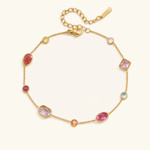 18K gold multicolor gemstone station bracelet flat lay - bezel-set mixed-cut crystals in coral, raspberry, blush, lilac, aqua, and citrine tones with adjustable gold chain and extender