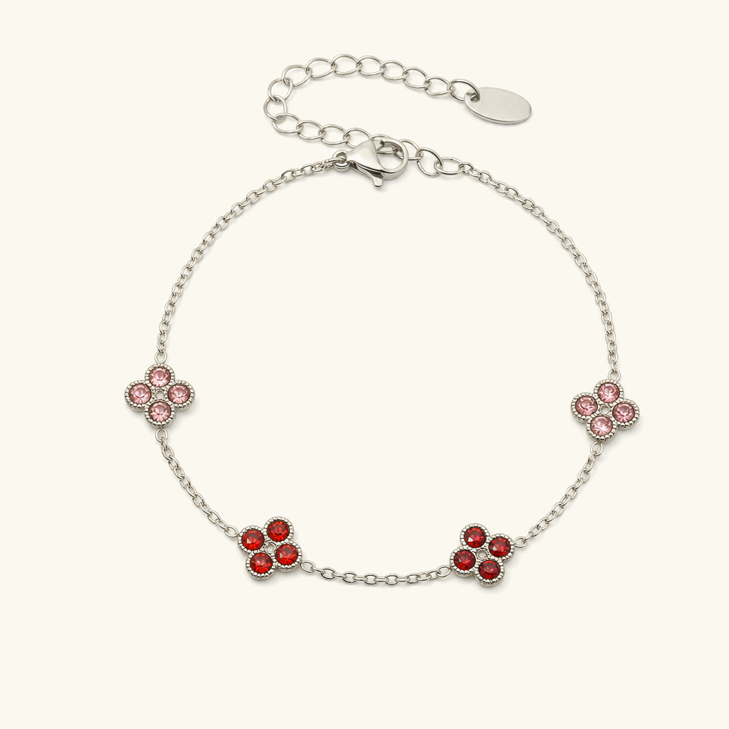 Sterling silver four-leaf clover bracelet with ruby red gemstone charms, premium jewelry product view
