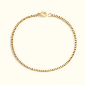 14K gold box chain bracelet flat lay, polished finish with secure lobster claw clasp, delicate square-link design