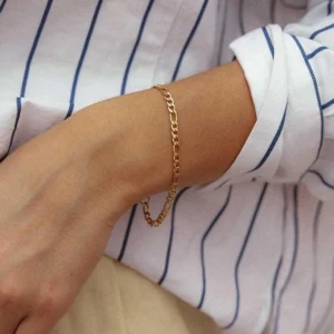 14K gold chain bracelet worn on wrist with curb link design close-up detail shot