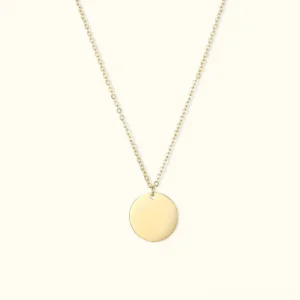 14K gold disc pendant necklace with polished round charm and fine cable chain, flat lay front view on light background