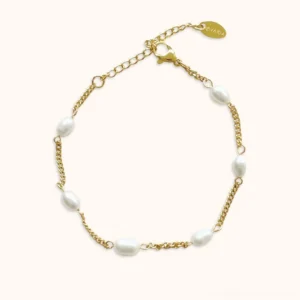 14K yellow gold freshwater pearl bracelet flat lay front view on neutral background featuring oval rice-shaped pearls clustered with delicate gold curb chain and adjustable extension charm