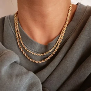 Layered 14K gold twisted rope chain necklaces worn at neck, two different lengths creating depth and dimension, close-up front view