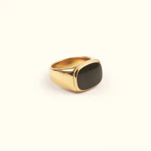 14K gold signet ring with black enamel rectangular inlay, polished finish, front flat lay view on beige background, minimalist geometric design