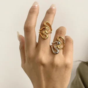 Abstract open rings worn on female hand, gold and silver two-tone version, close-up wearing demonstration