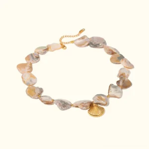 18K gold aquamarine seashell choker necklace flat lay overhead view showing iridescent pearl beads and gold shell pendant