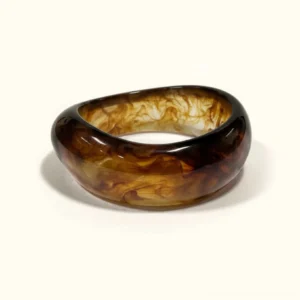18K gold sculpted autumn bangle in rich tortoiseshell brown with marbled pattern, chunky rounded design, flat lay product photography on light background