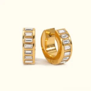 18k gold diamond huggie earrings with baguette cubic zirconia channel-set stones flat lay product shot