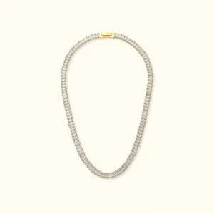 18K gold baguette tennis necklace with clear cubic zirconia stones and gold lobster clasp on light background