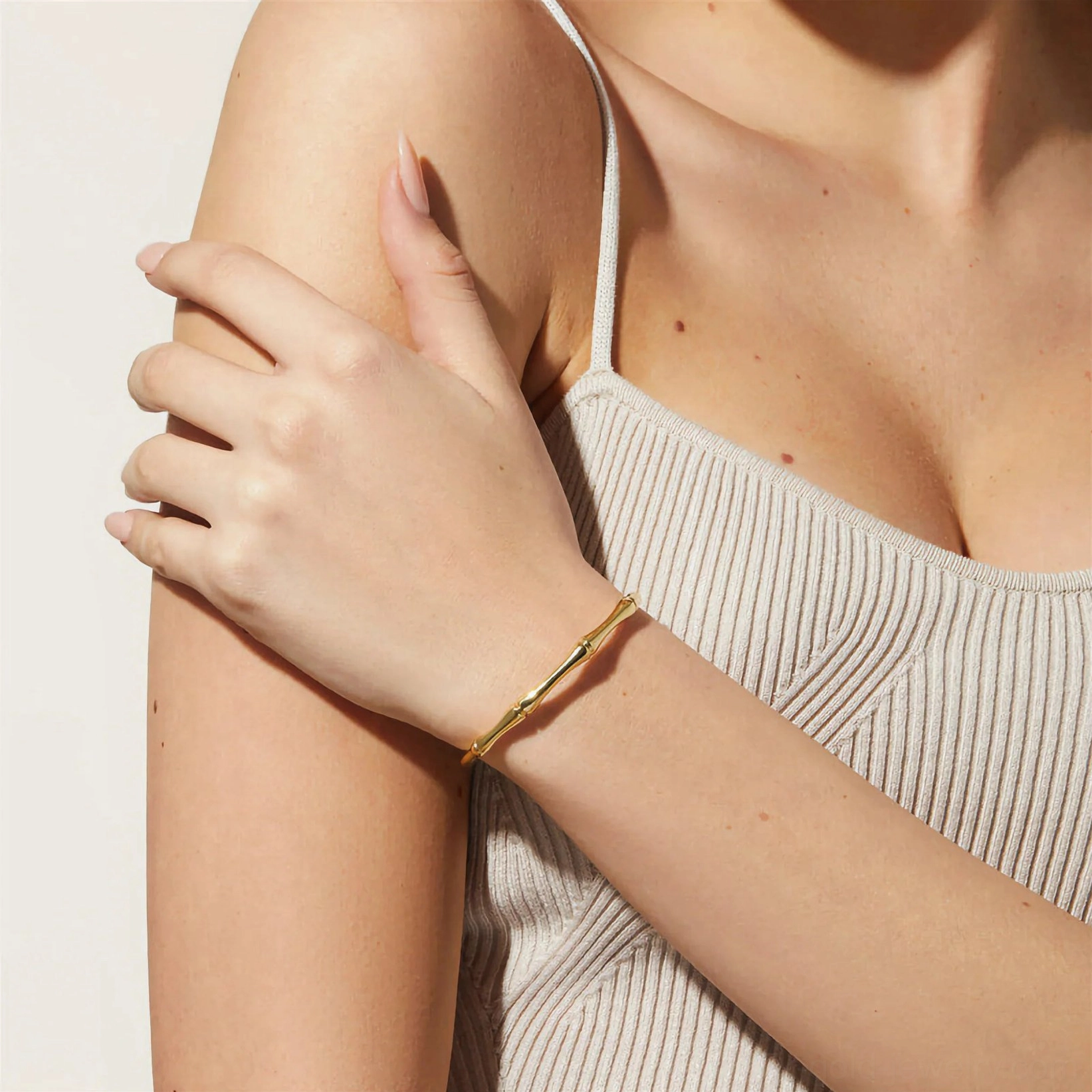 18K gold bamboo cuff bracelet worn on wrist side close-up view elegant slim fit band