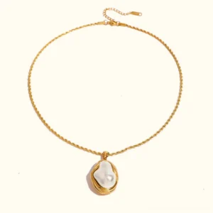 18K gold baroque pearl pendant necklace flat lay top-down view showcasing twisted rope chain and lustrous pearl with polished gold bezel frame