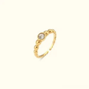 18K gold beaded adjustable ring with round cubic zirconia stone front flat lay view on light background showcasing polished gold finish
