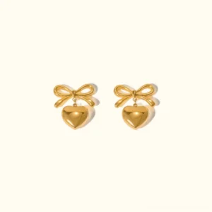 18K gold bow heart drop earrings flat lay frontal view polished shiny finish plain background