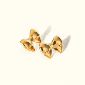 18K gold bow stud earrings pair top-down view on plain background, polished golden finish with ribbon-like design