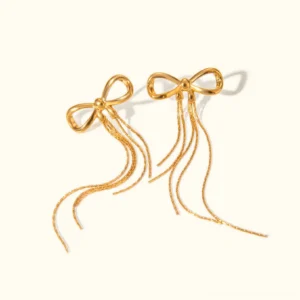 18K gold bow tassel drop earrings with twisted chain details, front view on neutral studio background
