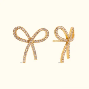 18K gold bow tie stud earrings with pavé cubic zirconia front view flat lay plain background