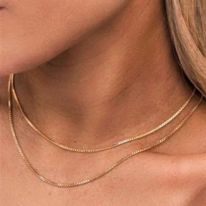 Double layer gold box chain necklaces worn on female model showing warm gold tone and neck fit