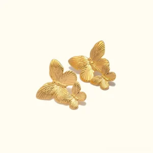 18K gold butterfly stud earrings flat lay front view with double butterfly design and textured striped wings on neutral background