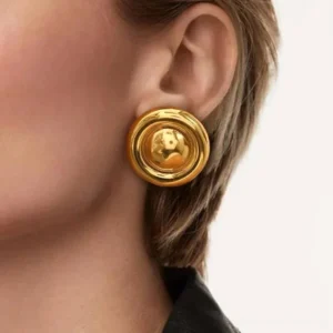 18K gold button earrings worn on ear close-up detail shot glossy finish jewelry