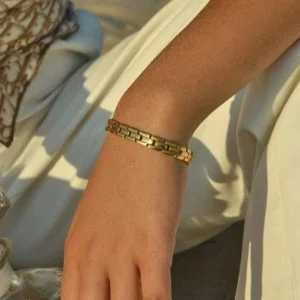 18K gold bracelet worn on female wrist close-up polished finish side view lifestyle styling