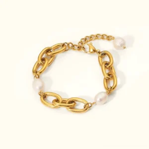 18K gold chunky freshwater pearl bracelet flat lay top view plain background polished gold links irregular white pearls