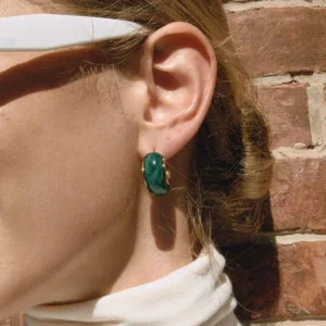 Model wearing green marbled enamel chunky hoop earrings with 18K gold inner trim, side view on ear