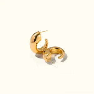 18K gold chunky hoop earrings polished finish top-down flat lay view on neutral background