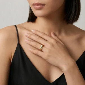 18K gold signet ring worn on left middle finger, paired with black camisole, upper body lifestyle shot