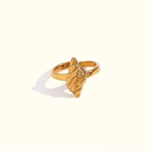 18K gold conch shell ring side view on plain background showcasing textured seashell design