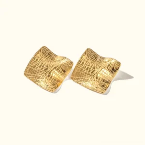 18K gold creased wave stud earrings flat lay top view showing textured square design on off-white background