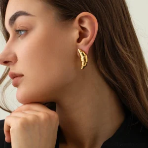 woman wearing 18K gold croissant stud earrings elegant side profile close-up