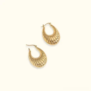 18K gold croissant hoop earrings with textured ridged crescent design, studio flat lay view on white background
