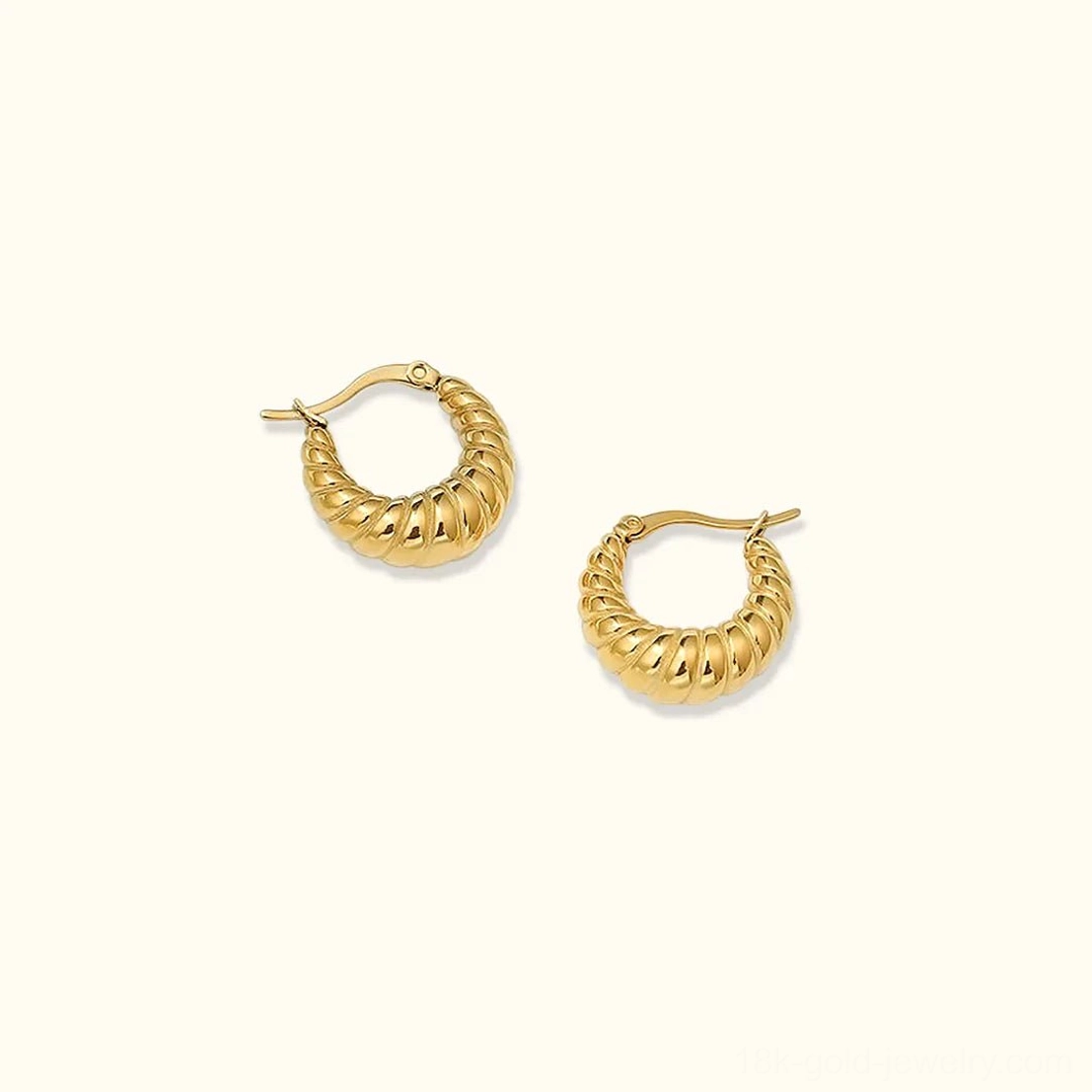 18K gold croissant hoop earrings with twisted texture ridged surface displayed on white background