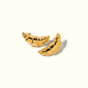 18K gold croissant stud earrings flat lay luxury jewelry premium finish