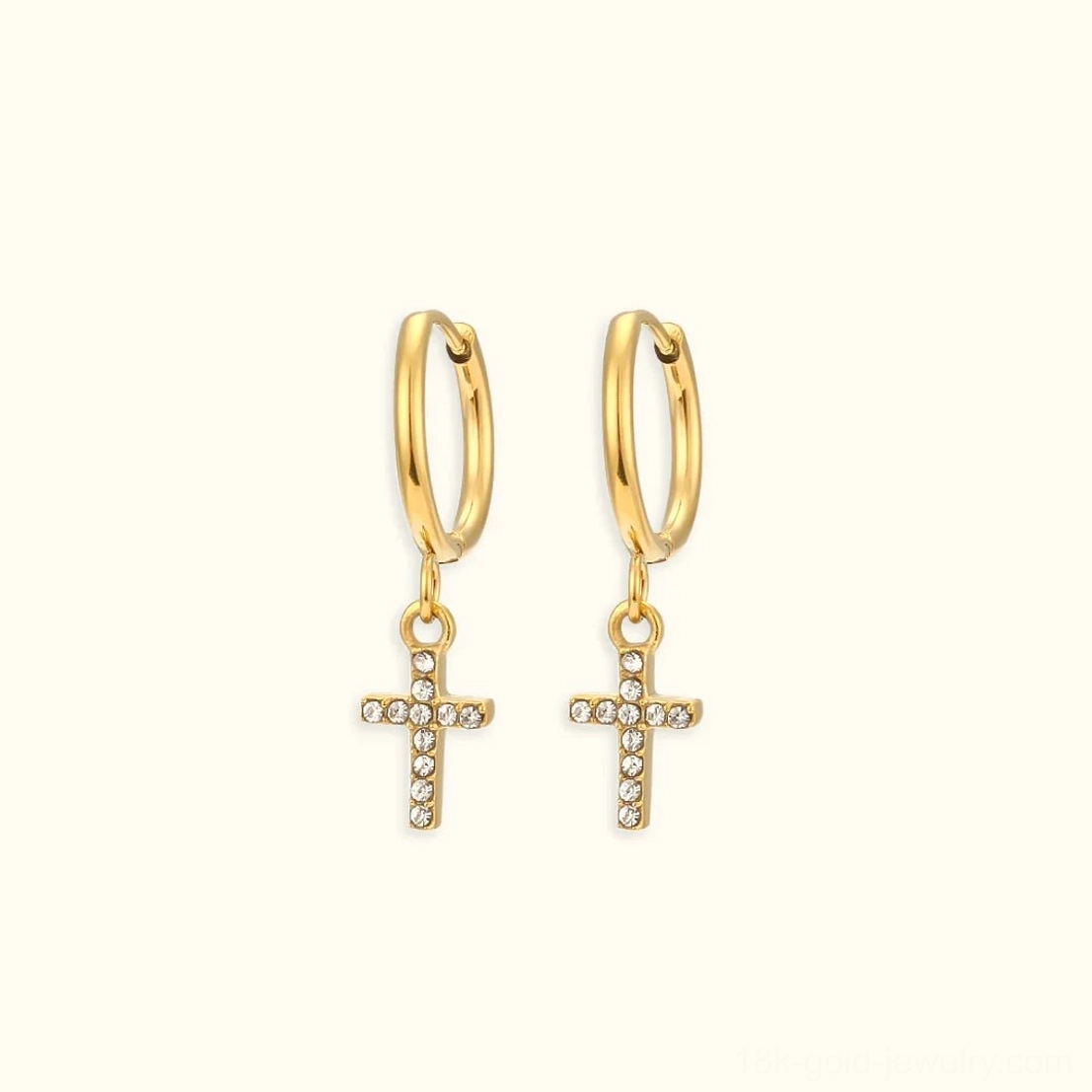 18K gold cross-shaped huggie hoop earrings with cubic zirconia charm spiritual jewelry flat lay